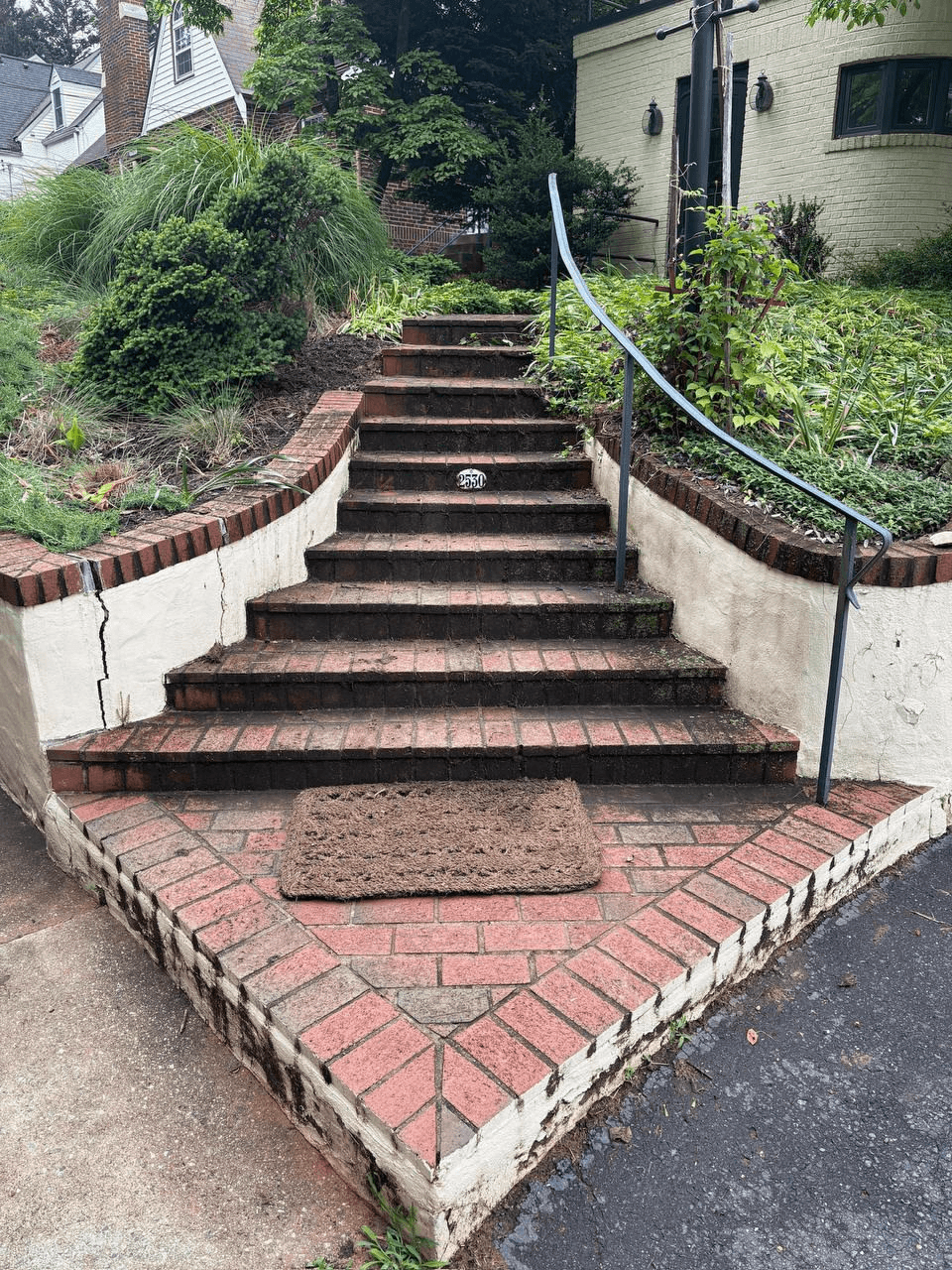 Brick staircase before soft washing — covered in moss and grime