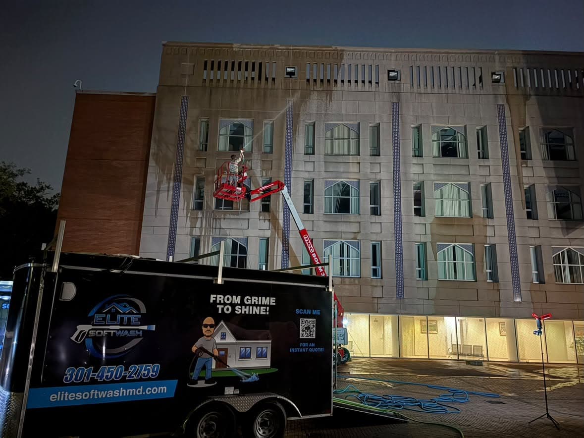 commercial building washing at night from a boom lift, full precast facade elevation, Washington DC area